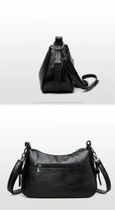 Detail of black pebbled leather crossbody bag showing rear zipper pocket and strap buckle
