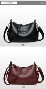 Detail of soft leather handbags in black and wine red with gold kangaroo logo and zipper