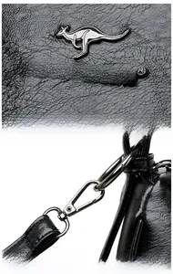 Detail of black pebbled leather handbag with silver kangaroo metal logo and clip