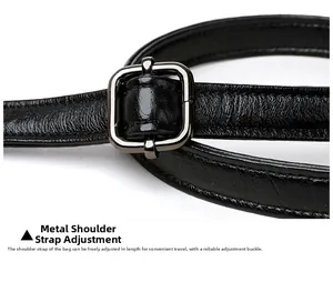 Detail of adjustable black leather shoulder strap with durable dark grey metal buckle