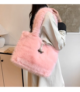 Detailed view of pink plush tote bag with wooden toggle button and soft faux fur texture
