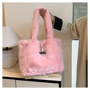 Detailed view of pink faux fur tote bag with toggle button closure on white cabinet