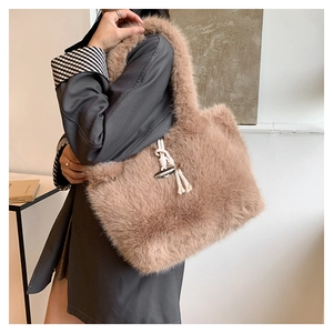 Detail of camel faux fur tote bag with vintage horn buckle and soft plush texture