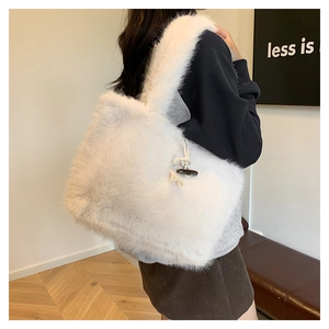 Detail of white faux fur tote bag showing the vintage toggle button closure and soft texture