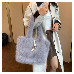 Detail of lavender faux fur tote bag featuring a vintage wooden toggle closure