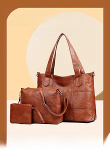 Detailed view of 3-piece brown faux leather tote bag set with pebble texture and silver hardware