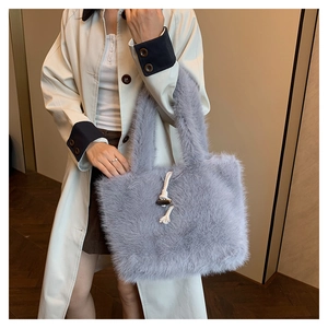 Close-up of fluffy faux fur tote bag featuring a wooden horn buckle and woven cord