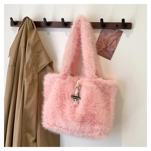Detail of pink faux fur tote bag featuring a vintage toggle button and soft plush texture