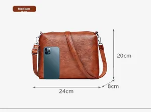 Close-up of brown vintage leather tote bag with smartphone for size reference