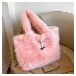 Detail of pink faux fur tote bag featuring cream rope decor and dark toggle closure