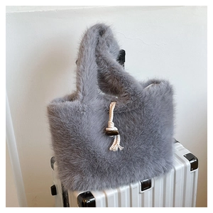 Detail of grey faux fur tote bag with white cotton rope handle and wooden fastener