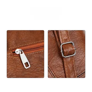 Detailed macro view of the smooth metal zipper and brown leather texture on a tote bag