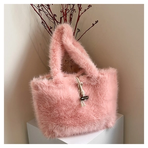 Detail of pink faux fur tote bag featuring a wooden olive button and woven cord closure