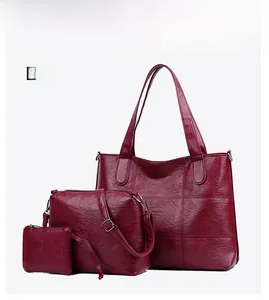Detailed view of 3-piece red PU leather tote bag set with textured finish and shoulder strap
