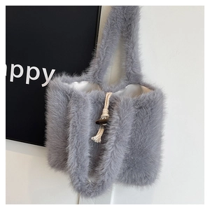 Detail of grey plush tote bag featuring a white lining and wooden toggle button closure
