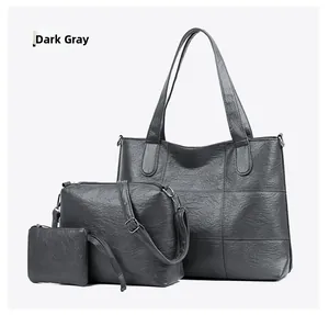Three-piece dark grey tote bag set with crossbody bag and coin purse in pebbled leather