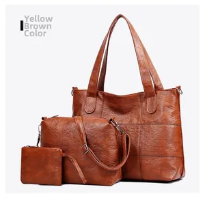 Three-piece yellow brown tote bag set including crossbody and clutch in textured leather