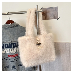 Detail of plush tote bag with horn buckle closure and faux fur texture on display