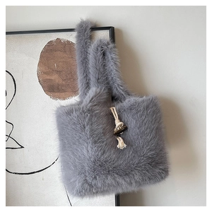 Detailed view of gray faux fur tote bag with vintage wooden toggle button closure