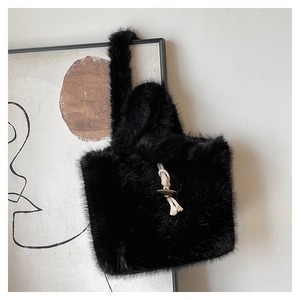 Close-up of black faux fur tote bag showing texture with wooden button and cord detail