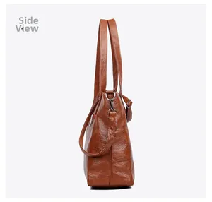 Side view of brown faux leather tote bag with vintage texture and silver metal hardware