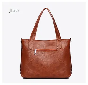 Rear view of brown lychee texture tote bag featuring a silver metal zipper back pocket