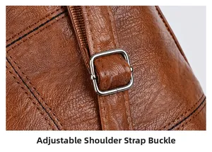 Detail of brown faux leather shoulder bag with adjustable silver metal buckle and stitching