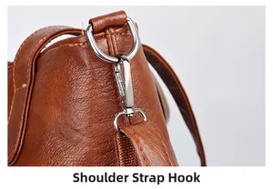 Close-up of brown leather shoulder strap with silver metal D-ring and lobster clasp