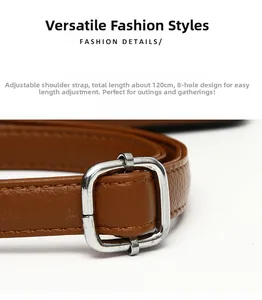 Adjustable brown leather shoulder strap with silver buckle and 8 holes for bags