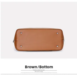 Detail of brown leather tote bag bottom with four protective silver metal feet