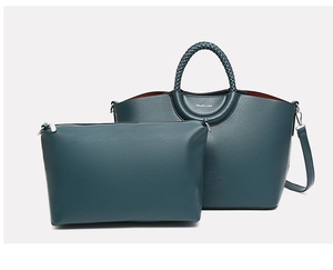Detail of dark green tote bag set with pebble faux leather and woven handles