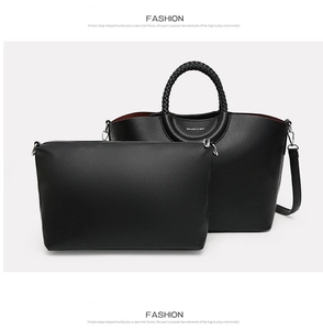 Detail of black tote bag with woven handles and matching inner pouch set in lychee texture
