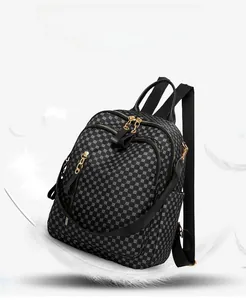 Close-up of lightweight geometric textured backpack with gold dual zippers and pockets