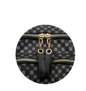 Detail of vintage floral backpack featuring premium gold-tone dual zippers and leather pulls