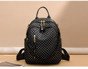 Detail view of large-capacity vintage travel backpack with gold zippers and geometric patterns