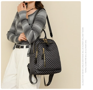 Detailed side view of geometric pattern backpack with gold zippers shown on a model