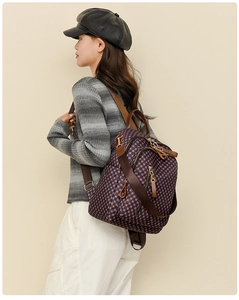 Side view of a vintage checkered backpack with red-brown straps on a model