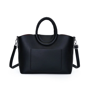 Black pebbled leather tote bag with woven handles and contrasting red lining