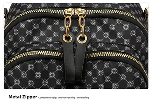 Close-up of golden dual-zipper closure on black floral vintage travel backpack