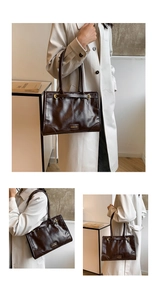 Details der dunkelbraunen Vintage-Einkaufstasche mit glänzendem Leder und Goldschnallen