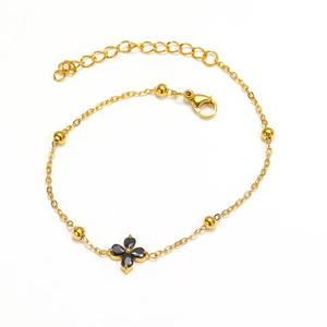 Elegant gold-plated titanium steel bracelet with black clover pendant and bead accents