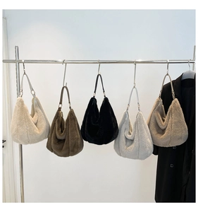 Detailed display of five colorful faux fur hobo bags hanging on a rack for autumn