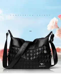 Detail of black pebbled leather shoulder bag with kangaroo logo and woven texture