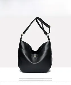 Close-up of black pebbled leather hobo bag with gold hardware and adjustable strap