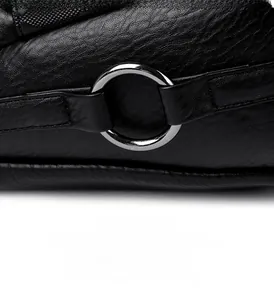 Close-up of litchi texture black leather and silver metal ring on the shoulder strap