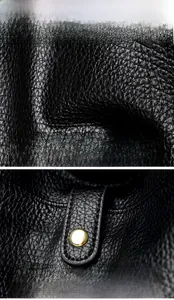 Close-up of black lychee grain leather texture with golden rivet hardware detail