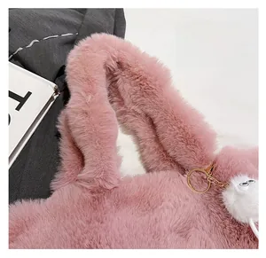 Detail of pink plush tote bag showing wide comfortable strap and fluffy faux fur texture