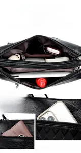 Internal compartments of black leather bag showing phone pocket and zipper sections