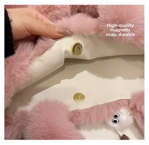 Detail of pink plush bucket bag showing magnetic snap closure and soft faux fur texture