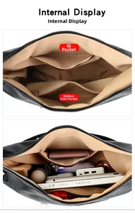 Detailed internal display showing spacious compartments of a black pebble leather handbag
